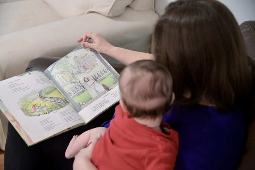 baby and mom reading book